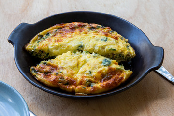 Frittata made of eggs, bacon, cheese and spinach