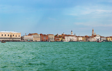 Venice, Italy - CIRCA 2013: Colorful buildings of Venice at a cloudy summer afternoon; as seen from...