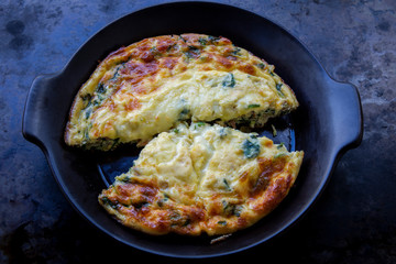 Frittata made of eggs, bacon, cheese and spinach