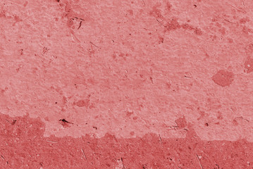 Old asphalt surface close up. Abstract background red color toned
