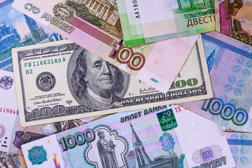 Fototapeta na wymiar American one hundred dollars banknote on the many russian rubles