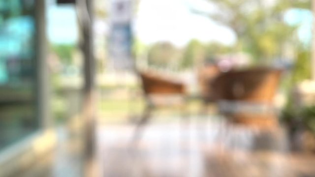 blur scene outdoor cafe with table seat outside garden view in the morning
