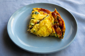 Frittata made of eggs, bacon, cheese and spinach