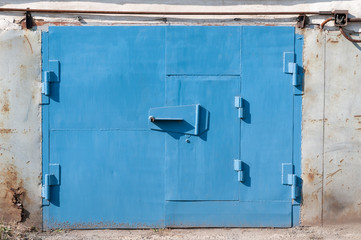 Old blue garage doors closed background