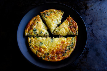 Frittata made of eggs, bacon, cheese and spinach
