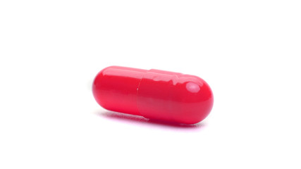 red capsule isolated on a white background. medical capsule