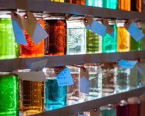 Glass jars filled with colored liquid