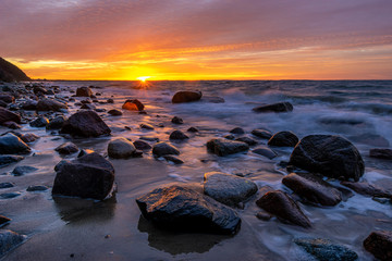 Fototapeta na wymiar Fiery sunset over the Baltic shore.