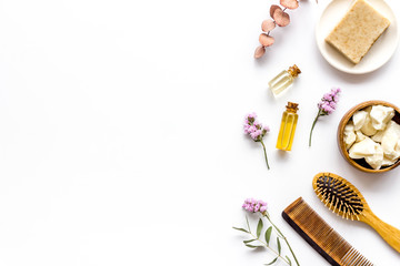 Obraz na płótnie Canvas Cosmetics for hair care with argan and jojoba oil on white background top-down frame copy space
