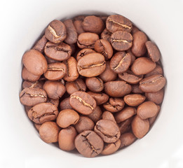 Coffee beans in a white glass close-up