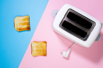 Toaster and bread slices Cooking bread in a toaster on a pink background close up. top view - obrazy, fototapety, plakaty