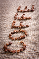 Word from coffee beans on burlap