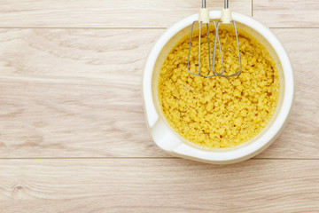 Cake batter in bowl with stir bar on wood