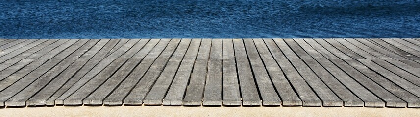 Close up of a wooden board walk along a little lake - Powered by Adobe