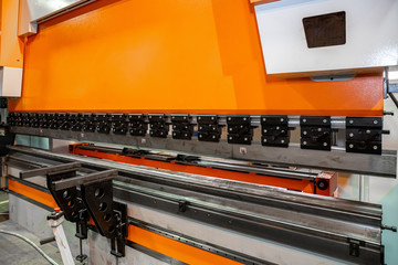 orange hydraulic press for metal at a metal processing plant