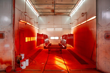 industrial painting in the chamber, spray gun, artificial lighting