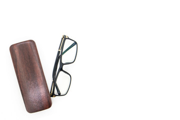 Spectacles (Eye glasses) with black frame and wooden case, isolated on white background.