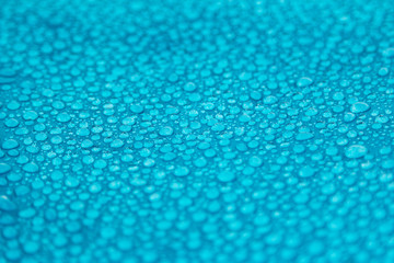 different drops of water on a blue background