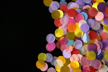 Confetti Background.  multicolored motley confetti on a black background.