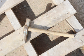 hammer lying on wooden pallet  at construction site