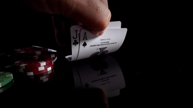Poker chips and cards blackjack in a dark studio professionally shot and lit with wide angle macro lens