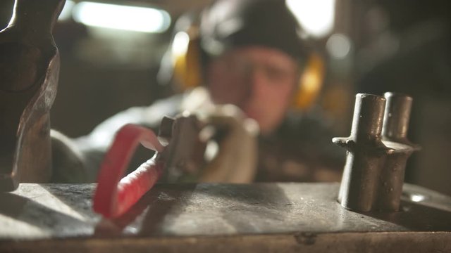 Blacksmith forging a metal handle with unusual design