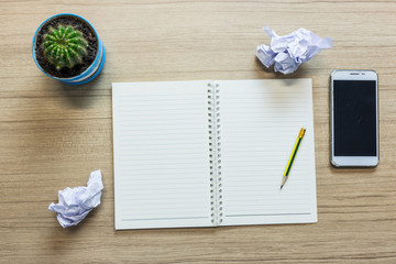 Notebook and another on wooden desk.