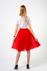 girl in a red skirt with high heels on a white background