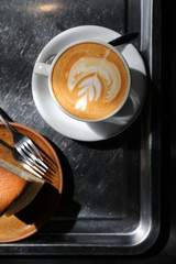 Hot cappuccino or Latte art coffee made from milk on the wood table in coffee shop