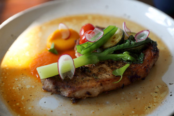 Grilled Porkchop and vegetables on top on wood background