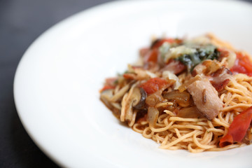 spaghetti Bolognese with minced beef and tomato sauce garnished with parmesan cheese and basil , Italian food