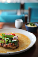 Grilled Porkchop and vegetables on top on wood background