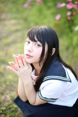 Portrait of beautiful Asian japanese high school girl uniform looking with bamboo forest background