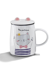 Subject shot of a white ceramic mug with a picture of a cat in a sailor's striped vest, a cover with cat's ears and lettering 