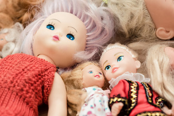 Fototapeta na wymiar Many old dolls lies on floor in children room