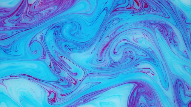 Abstract paint ink in motion. Psychedelic ebru background footage. Flowing colorful spots.