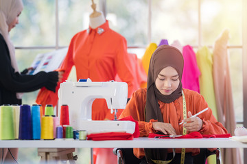 portrait of young attractive muslim woman fashion designer in her workshop