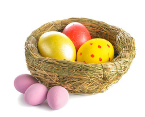 Nest with beautiful Easter eggs on white background