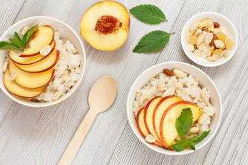 Sorghum salad with nuts and fresh peach on wooden boards.