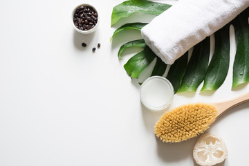 Monstera leaf, brush, coffee beans, SPA set for cellulite removal and wellness . Copy space. - obrazy, fototapety, plakaty