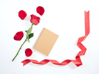 Single red rose on a diary.
