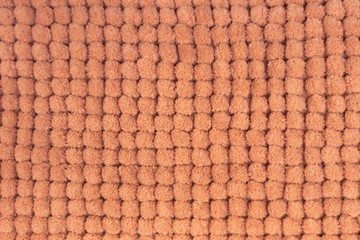 Blurred texture of soft orange flannel rug. Soft honeycomb background.