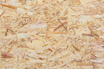 Fototapeta na wymiar The texture of a wooden sheet of pressed sawdust. Background for design.