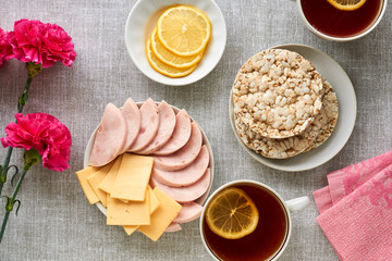 Breakfast with ham and cheese on a gray fabric background