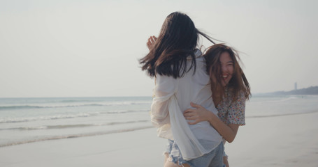 Girlfriends couple LGBT young asian run playing catch on seaside beach, Freedom relaxation, resting summer vacation sunset people lifestyle concept