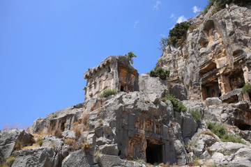 Fototapeta na wymiar A large ancient tomb on a mountain in the ancient city of Myra in Turkey.