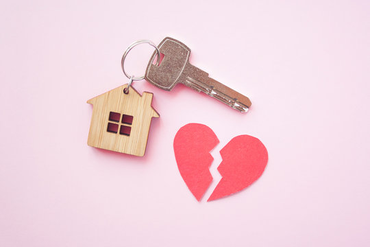 Wooden House Toy And Silver Key With Broken Heart On Bright Pink Background. Mortgage, House Buy Sell, Investment, Rent, Realtor Concept, Cheating, Problems And Poverty Concept