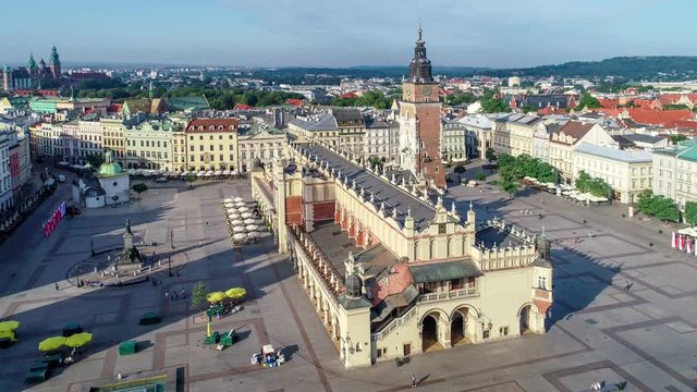 Krakow, Poland. Aerial video of old city, with Main Market Square (Rynek), old drapers&rsquo; hall (Sukiennice), Mickiewicz statue, St. Adalbert small church and far view of Wawel castle and cathedral