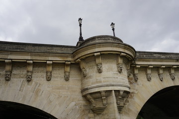 Fototapeta premium closeup of the carvings and stone work on an old bridge in downtown Paris, france