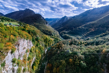 Fototapeta na wymiar Green mountain panorama with steep cliffs, mountain peaks, river Tara and mountain horizon. Montenegro canyon in Durmitor national park
